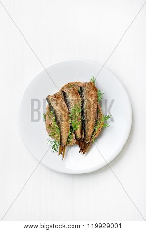 Sprats Sandwiches On White Plate