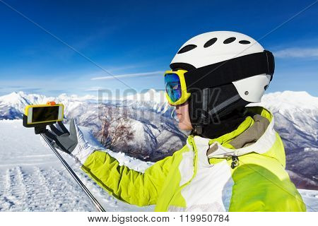 Woman with selfie stick on the mountain