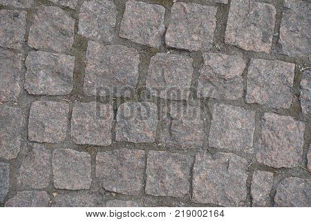 Road paved with small rectangular granite setts