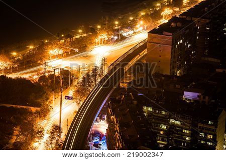 Aerial night view of a road junctions with cars lights trail in Wuhan central China