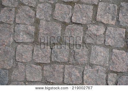Texture of dusty road paved with setts