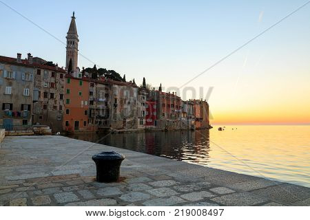 Sunset at medieval town of Rovinj colorful with houses and church in Croatia