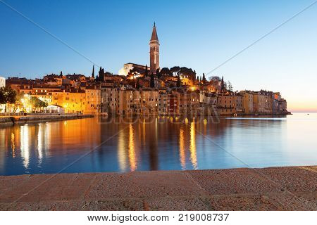 Sunset at medieval town of Rovinj colorful with houses and church in Croatia