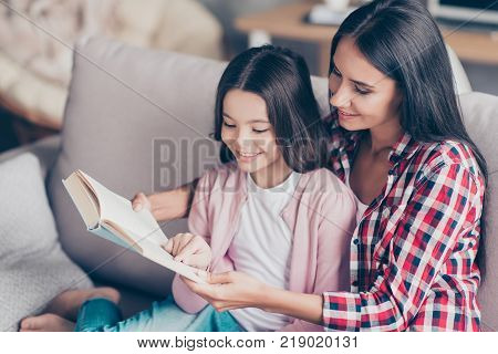 It's So Interesting And Exciting! Young Smiling Mother Is Reading A Funny Book For Her Cute Sweet Li