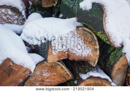 Close up pile of wood covered with snow