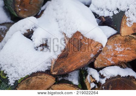 Close up pile of wood covered with snow