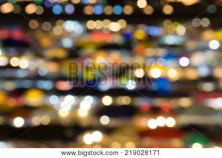 defocused of multi color light and plastic roof of ratchada train night marketbangkok. for christmas and new year abstract background concept.