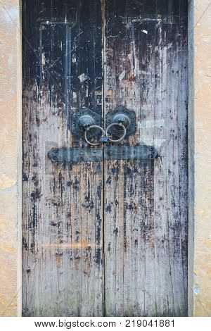 Old wooden door in the Chinese temple. The door is locked