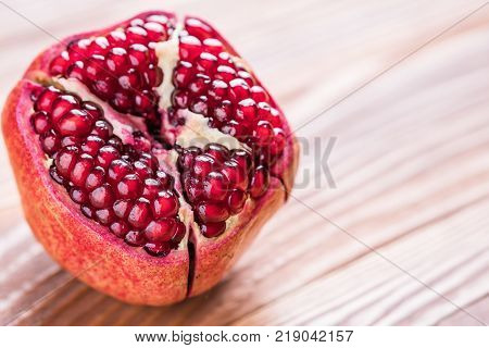 Big red pomegranate on the wooden board. Ripe granet fruit.