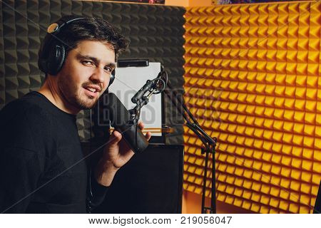 Microphone in radio studio and presenter on background