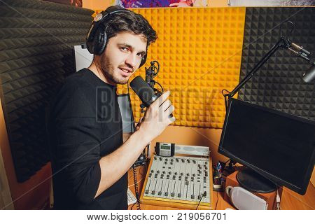 Microphone in radio studio and presenter on background