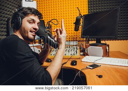 Microphone in radio studio and presenter on background