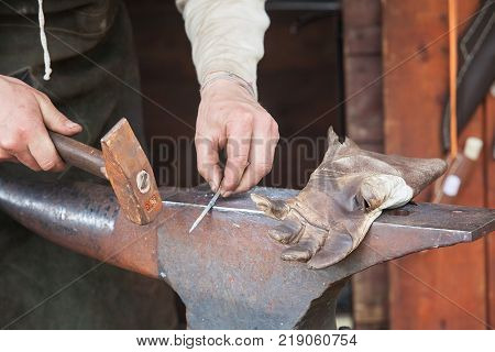 Detail shot of metal being worked at a blacksmith forge