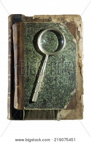 Two ancient shabby books and a magnifying glass for reading isolated on each other