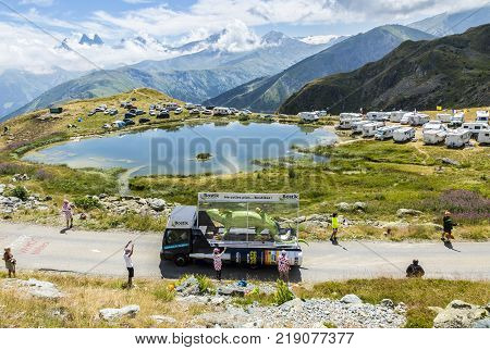 Col de la Croix de Fer France - 25 July 2015: Bostik caravan driving on the road to the Col de la Croix de Fer in Alps during the stage 20 of Le Tour de France 2015.