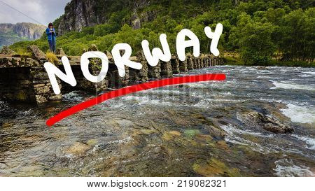 Tourist woman standing on stone slab bridge Terland Klopp in Norway Dalane region.