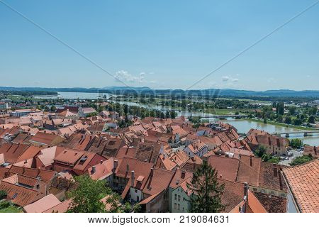 Ptuj / Slovenia - August 17, 2017: View of the old town, the river Drawa and the lake from the castle in Ptuj in the summer of 2017