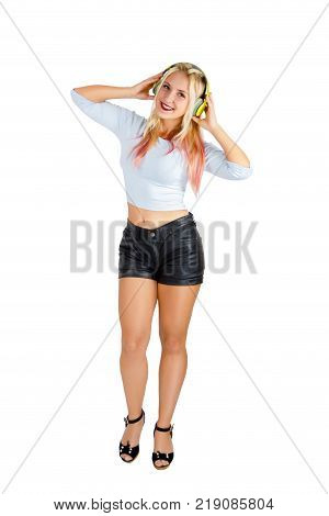 happy smiling pretty girl holdind wireless yellow headphones and listen to music isolated on white background