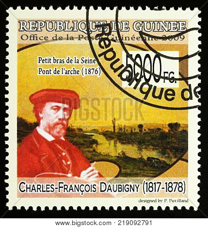 Moscow Russia - December 19 2017: A stamp printed in Guinea shows French artist Charles-Francois Daubigny (1817-1878) and his picture 