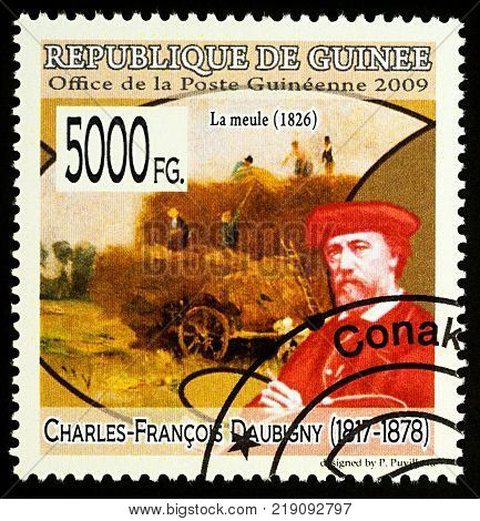 Moscow Russia - December 19 2017: A stamp printed in Guinea shows French artist Charles-Francois Daubigny (1817-1878) and his picture "Hay stack" series circa 2009