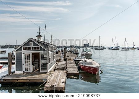 Rows of sailing boats and luxury yachts anchored in Boston harbor. Names and trademark are revomed.