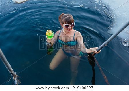 Novokuznetsk, Kemerovo region, Russia - 23 Feb, 2017 : White beaches of Siberia is an enterteiment activity where people playing beach games dressed in bikini in winter. Woman in an ice hole