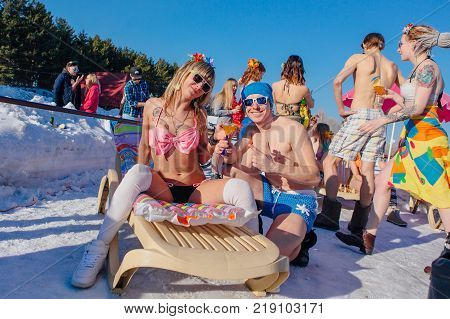 Novokuznetsk, Kemerovo region, Russia - 23 Feb, 2017 : White beaches of Siberia is an enterteiment activity where people playing beach games dressed in bikini in winter. Woman in bikini and a man