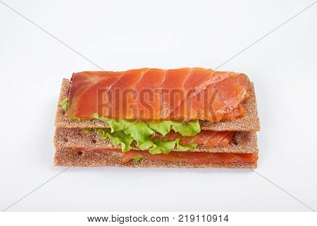 Low caloric open sandwich with salmon. Isolated on white background.