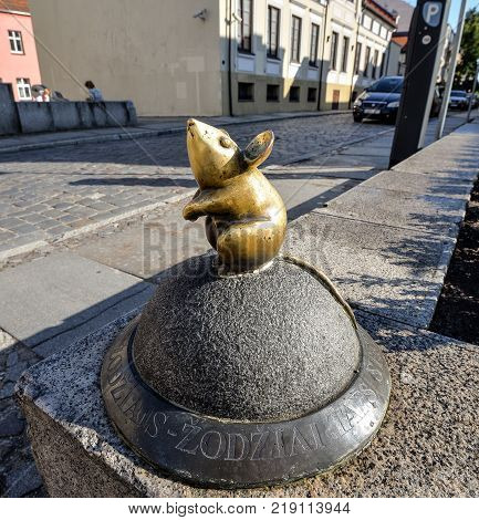 Klaipeda, Lithuania - August 16, 2017: Beautiful little magic mouse, Klaipeda, Lithuania. One of Klaipeda's charming, small street sculptures Golden Mouse