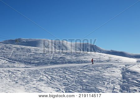 Skier downhill on ski at cold sun morning. Georgia region Gudauri. Caucasus Mountains in winter.