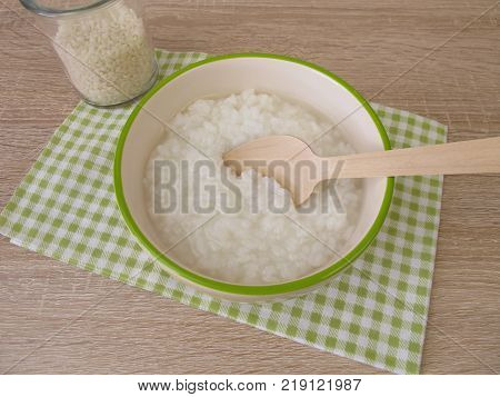 Congee with rice in bowl and glass of rice