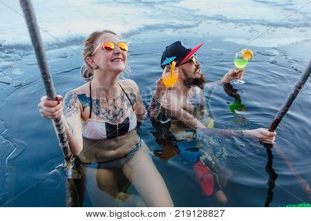 Novokuznetsk, Kemerovo region, Russia - 23 Feb, 2017 : White beaches of Siberia is an enterteiment activity where people playing beach games dressed in bikini in winter. Couple in ice hole