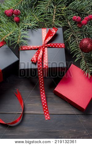 Red Christmas  Gift  Box With Red Ribbon And Fir Branches