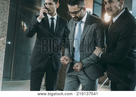 view of security guards going with male suspect