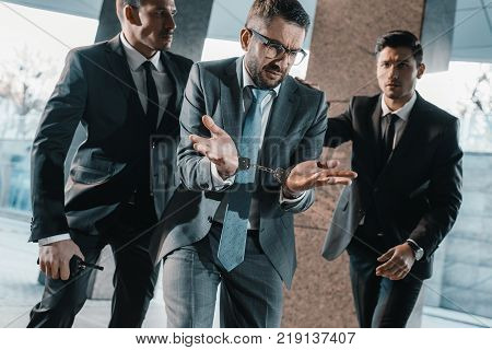 male offender showing security guards shrug gesture