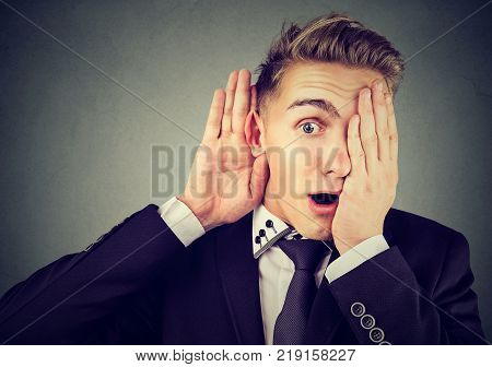 Funny looking man eavesdropping listing into private conversation