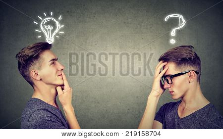 Two men thinking one has a question another solution with light bulb above head isolated on gray background.
