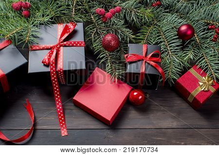Red Christmas  Gift  Box With Red Ribbon And Fir Branches