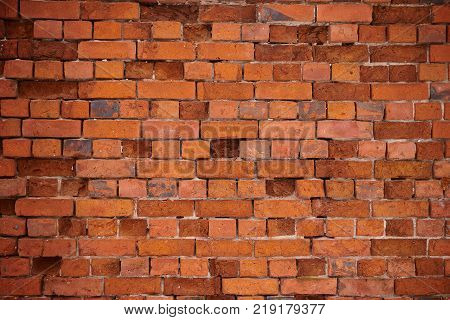 The texture of an old wheatered red brick wall, background
