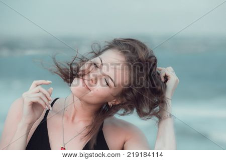Portrait of beautiful girl with disheveled hair