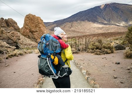 Super Mother Hiking With Toddler In Backpack