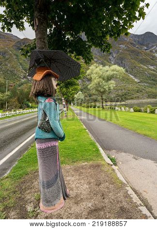 EIDFJORD, NORWAY - 21 SEPTEMBER 2017: Knitted woolen female on tree trunks in Eidfjord in Norway