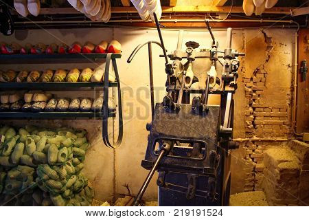 Machine for manufacturing wooden shoes Klompen in Holland. National traditional Dutch wooden shoes. Clog and Klomp Production Workshop