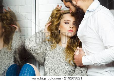Date flirt relationship romance. Man with beard kiss woman with long hair. Sensuality seduction concept. Couple in love hold hands.