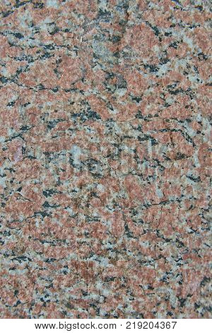 Facing material red granite texture. Natural stone granite background texture. Bright hard red granitic rock texture. Red granite granitic stone background texture. Red granite untreated surface.