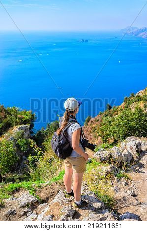 Woman photographer at Path of Gods in Tyrrhenian sea Amalfi coast Italy
