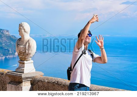 Ravello Italy - October 2 2017: Man making selfie at the terrace in Ravello village Tyrrhenian sea Amalfi coast Italy