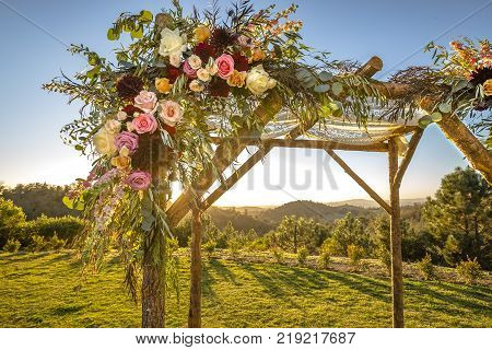 Outdoor sunset view of a Jewish traditions wedding ceremony. Wedding canopy chuppah or huppah .
