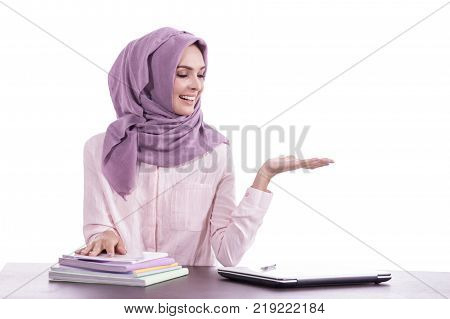 portrait of beautiful college student wearing hijab presenting copy space isolated on white backgorund