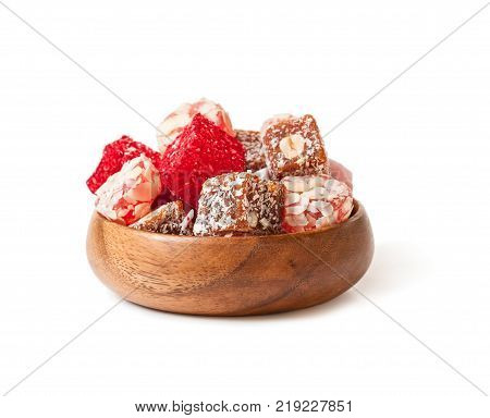 Assortment turkish delight in wooden plate isolated on white